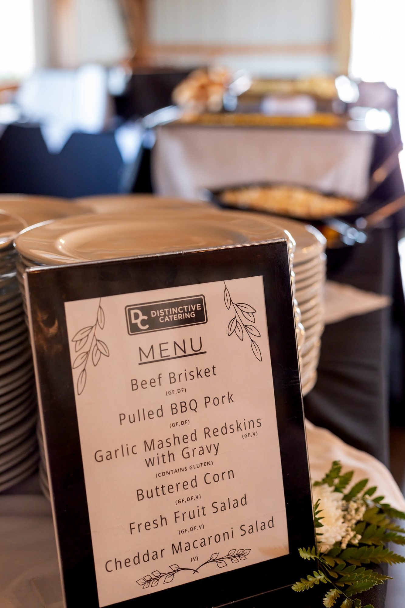 Distinctive Catering menu sign at a wedding reception at Ridge View Ranch