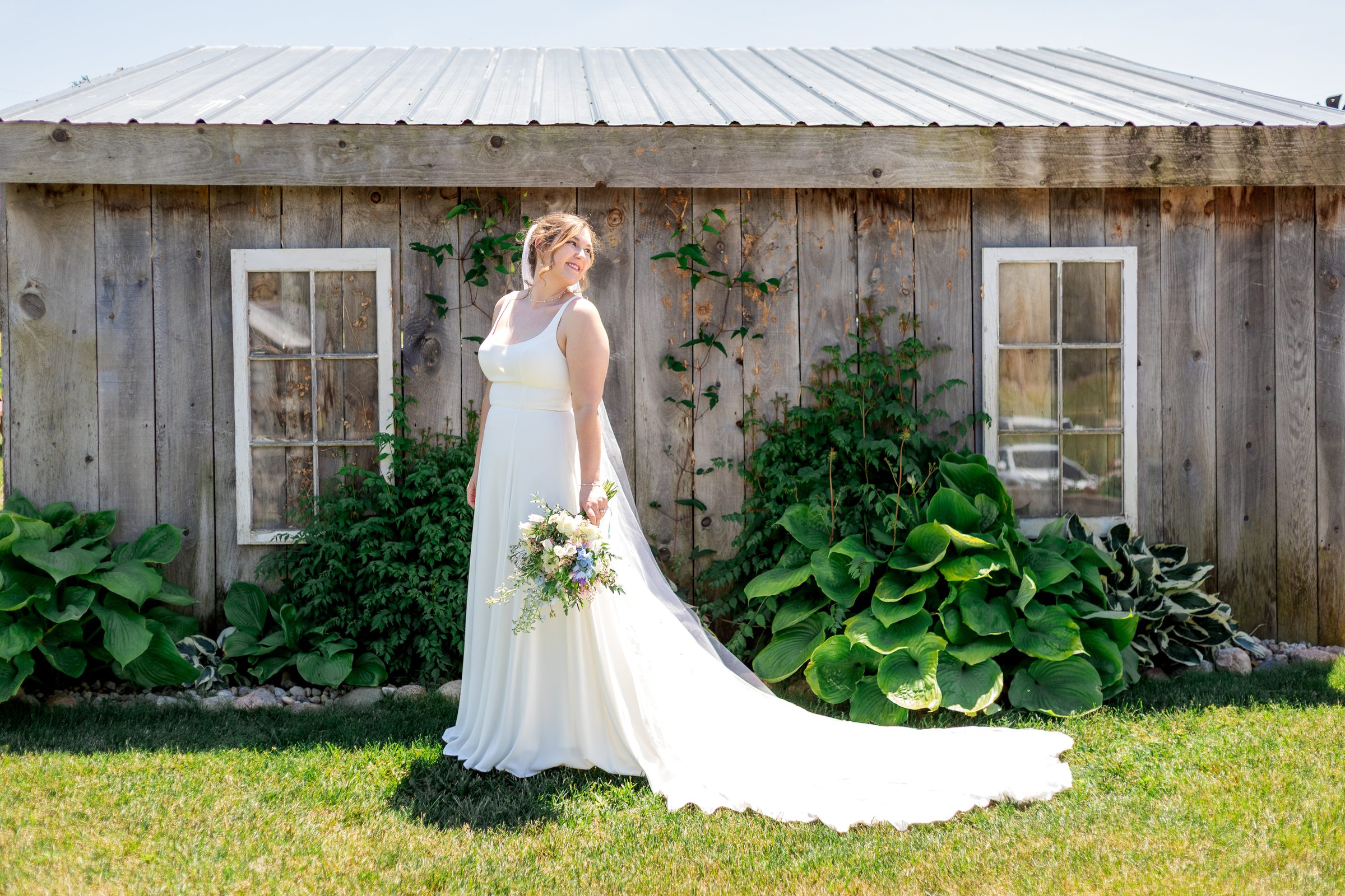 Bride outside the rustic shed at Ridge View Ranch barn wedding venue